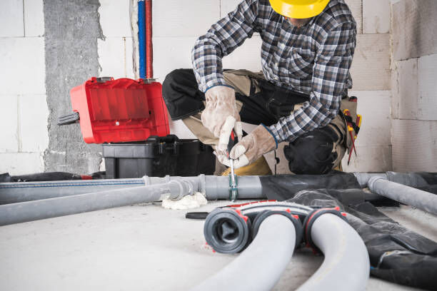 A professional installer working on an outdoor septic system.
